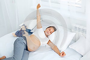 Pregnant Woman waking up in the Morning. Mom Expecting Baby. Bea