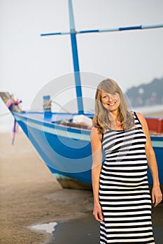 Pregnant woman walking along a beach