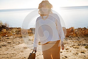 Pregnant woman walking near the river in the morning