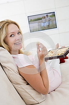 Pregnant woman watching television