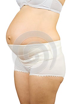 Pregnant woman wearing obstetrical binde photo