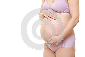 Pregnant woman wearing purple underwear touching her belly