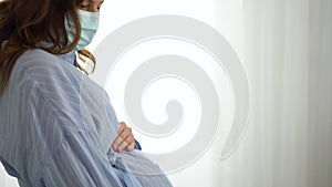 Pregnant woman wears medical mask to protect against a viral infection. Health care during pregnancy