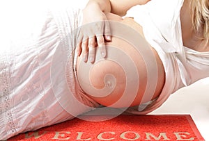 Pregnant woman on the wellcome-carpet