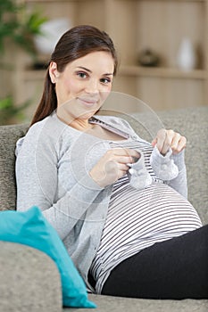 pregnant woman with white baby boots in handtoned photo