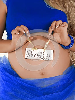 Pregnant woman with a white banner baby