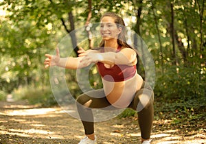 Pregnant woman working exercise in the forest Yoga time