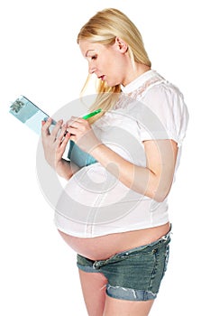 Pregnant woman writing a note photo