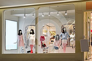 Pregnant women and children mannequins in fashion shop window