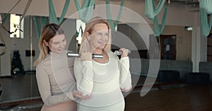 Pregnant women doing fitness exercise with dumbbells