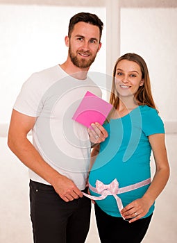 Pregnant woman and her man - studo photography of a young couple photo