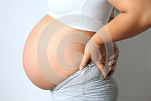 Pregnant women with low back pain on white background,Health con