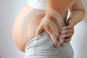 Pregnant women with low back pain on white background,Health concept