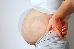 Pregnant women with low back pain on white background,Health concept