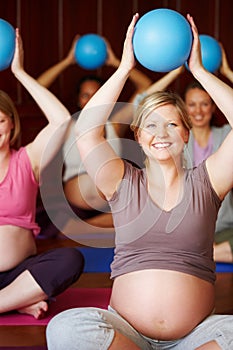Pregnant women, pilates class and healthy exercise with multicultural mothers sitting together in a wellness studio