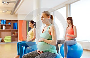 Pregnant women sitting on exercise balls in gym