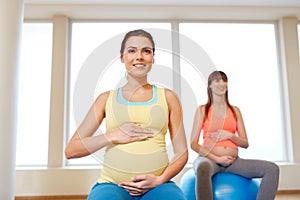 Pregnant women sitting on exercise balls in gym