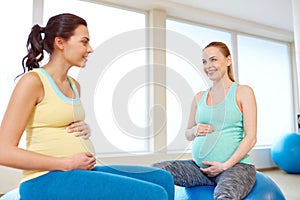 Pregnant women sitting on exercise balls in gym