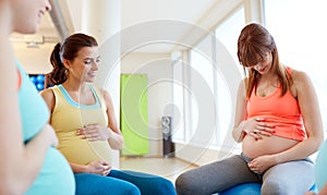 Pregnant women sitting on exercise balls in gym