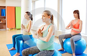 Pregnant women sitting on exercise balls in gym