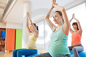 Pregnant women sitting on exercise balls in gym