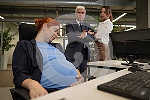 A pregnant woman sleeps at her workplace. Colleagues are indignant. photo