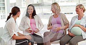 Pregnant women talking together at antenatal class