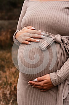 Pregnant women is touching her tummy