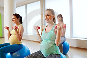 Pregnant women training with exercise balls in gym