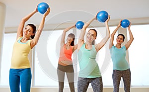 Pregnant women training with exercise balls in gym