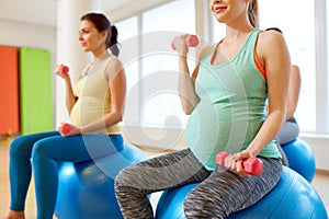 Pregnant women training with exercise balls in gym