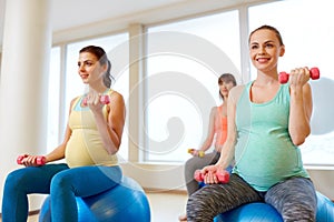 Pregnant women training with exercise balls in gym