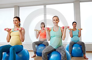 Pregnant women training with exercise balls in gym