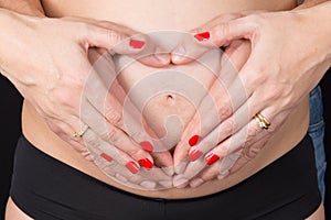 Pregnant women wrap her arms around the belly