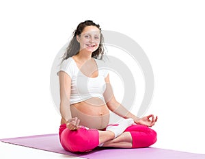 Pregnant yoga woman relaxing and meditating