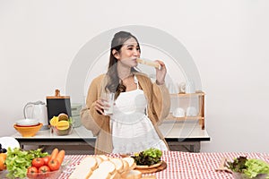 Pregnant Young Asian Woman Cooking vegetables. Healthy Food and drink - Vegetable Salad. Dieting. Dieting Concept. Healthy