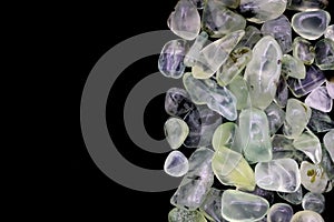 Prehnite heap jewel stones texture on half black background