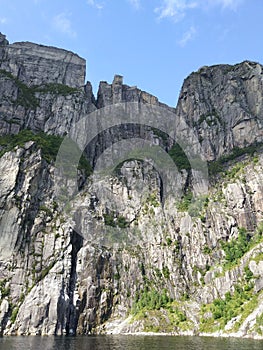 Preikestolen or Pulpit Rock. Bottom view of a giant cliff 604 m high above the Lysefjord, Norway. View
