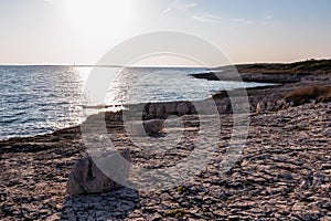 Premantura - Rocky shoreline along idyllic Cape Kamenjak National Park near Premantura, Istria, Croatia. photo