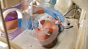 Premature baby in incubator. Newborn life support. Infant foot in intensive care hospital bed after birth. Newborn 1 day