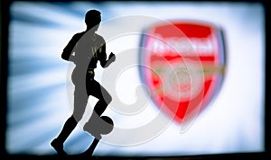 LONDON, ENGLAND, JULY. 1. 2019: Arsenal Football club logo, Premier League, England. Soccer player silhouette