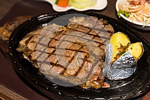 Premium American prime rib steak on a metal plate ready to serve