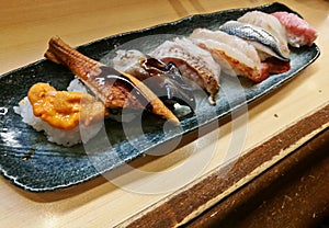 Sea urchin roe and unagi grilled sea fish sushi served fresh