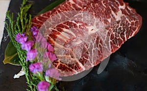 Premium raw marble beef black angus for grilling, serving on black plate. Japanese yakiniku