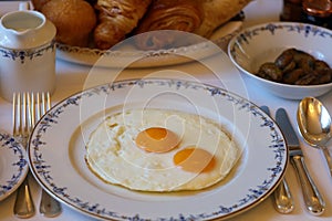 Premium sunny side up eggs with side potatoes, luxury breakfast unique cuisine in VIP gastronomy restaurant