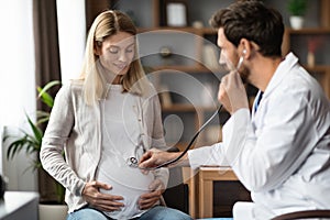 Prenatal Care. Obstetrician Doctor Doing Check In To Pregnant Woman In Clinic
