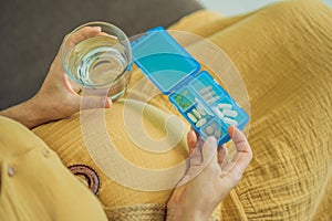 Prenatal Vitamins. Portrait Of Beautiful Smiling Pregnant Woman Holding Pill Box and a glass of water, Taking