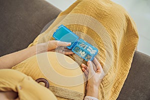 Prenatal Vitamins. Portrait Of Beautiful Smiling Pregnant Woman Holding Pill Box, Taking Supplements For Healthy