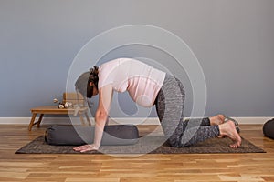 Prenatal yoga meditation. Pregnant woman doing yoga meditation at home