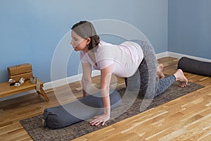 Prenatal yoga meditation. Pregnant woman doing yoga meditation at home